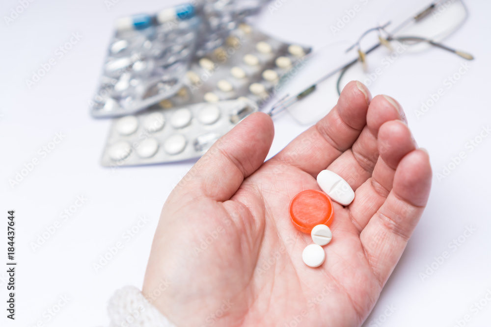 Pills holding in hand, white background and copy space Pills holding in hand, white background and copy space