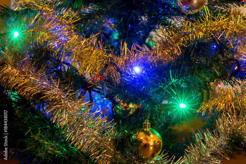 The detailed look at Christmas decorations with lighting bulb on Christmas tree.