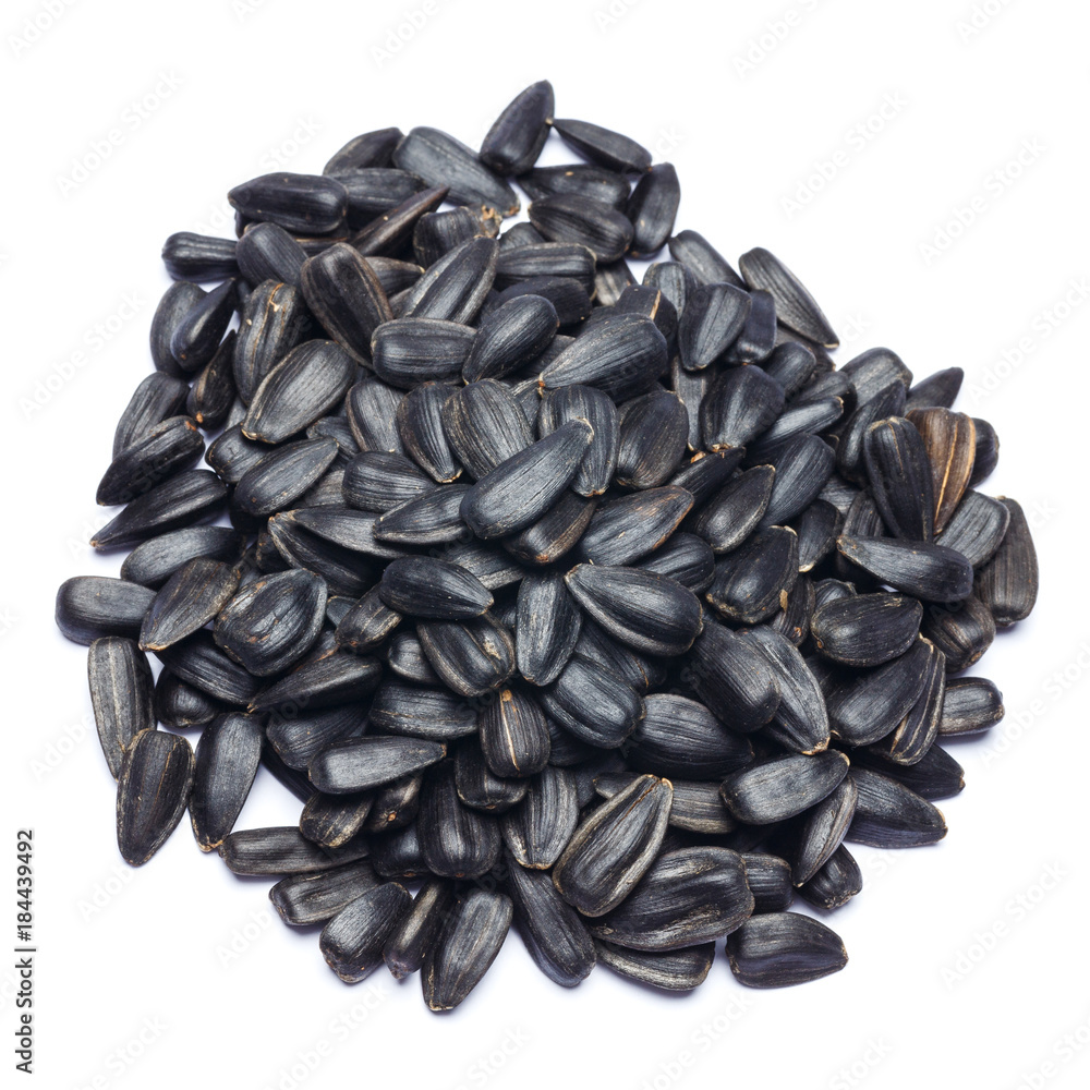 pile of seeds of a sunflower isolated on a white background pile of seeds of a sunflower isolated on a white background