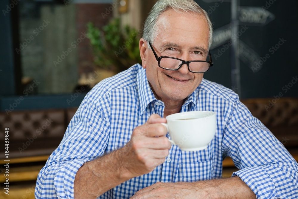 Portrait of happy senior man at cafe Portrait of happy senior man at cafe