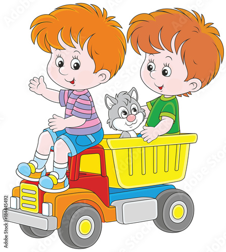 Little boys playing with a big toy truck and a small kitten