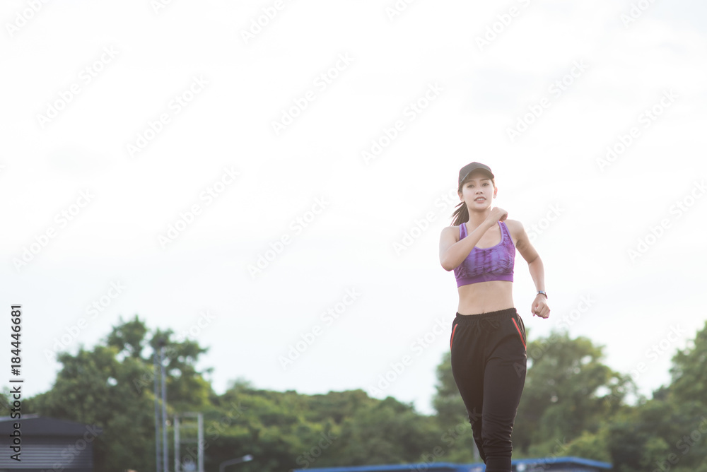 Young woman runner is jogging on the street be running for exercise. Selective focus Young woman runner is jogging on the street be running for exercise. Selective focus