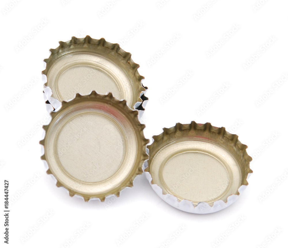 Decorative beer caps on white table Decorative beer caps on white table