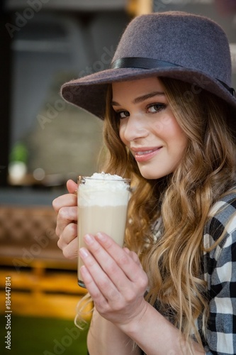 Portrait of young woman drinking cold coffee photo