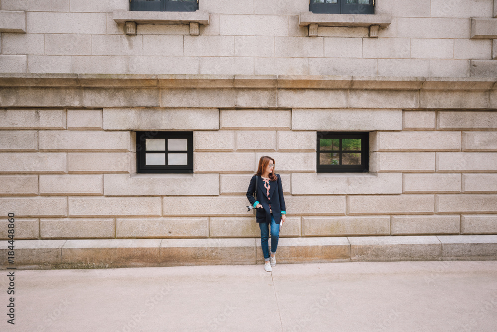Lifestyle and fashion. Young woman tourist standing in front of the old building in south korea. Lifestyle and fashion. Young woman tourist standing in front of the old building in south korea.