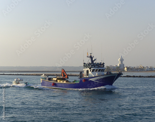 Fishing boat leaving the port for night fishing © Enrique