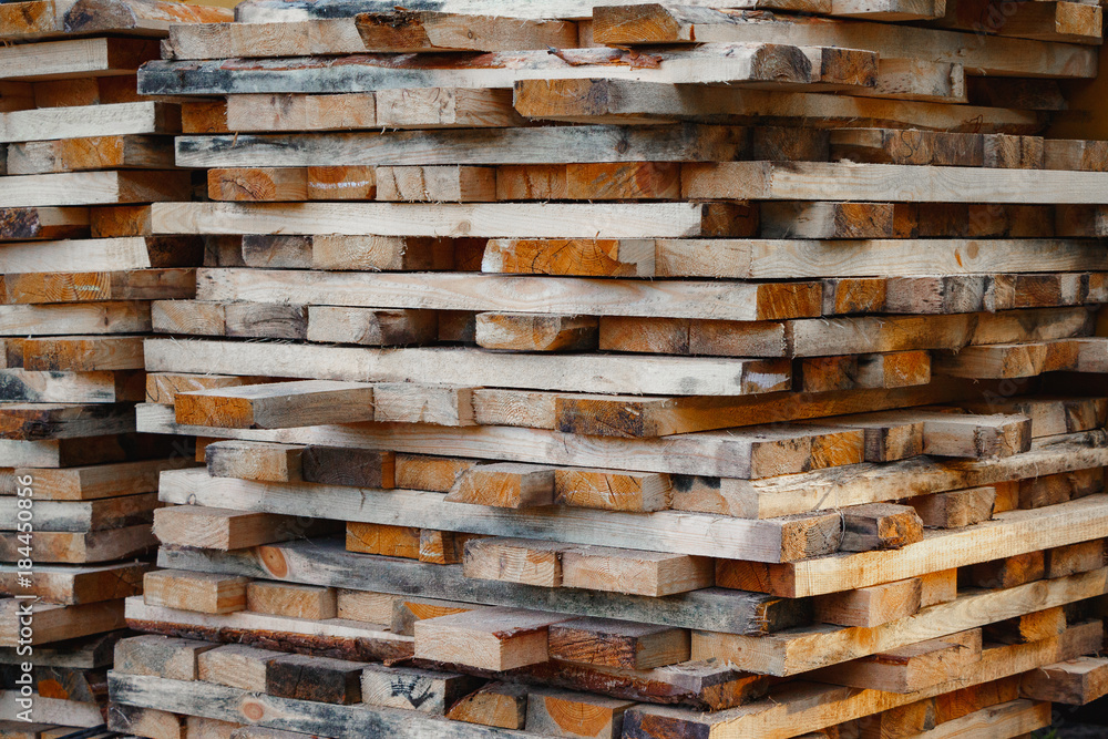 Stack of lumber. Timberwork, lumber work and woodwork industry concept. Close up old wooden timber planks.