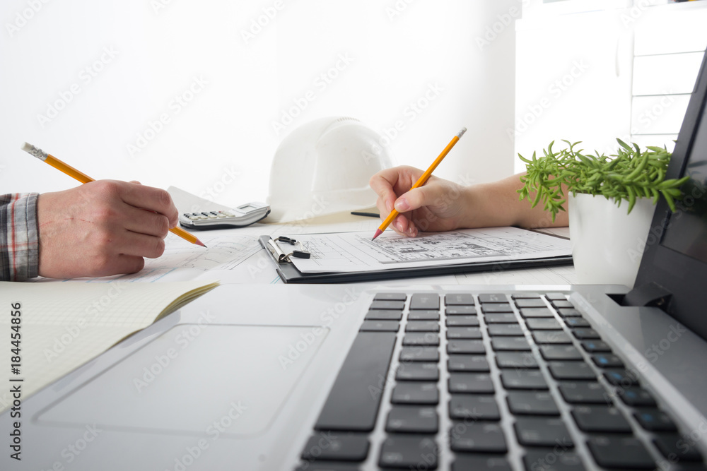 Architects working on blueprint, real estate project. Architect ...