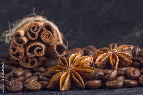Close-up, roasted coffee seeds, tubberry, cinnamon sticks and chocolate.
