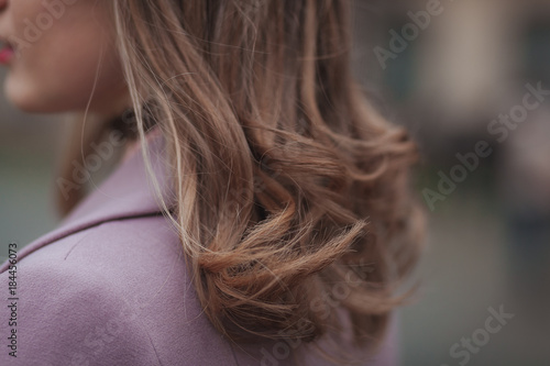 Stylish hairstyle concept. Light brown hair. Close up outdoor shot without face