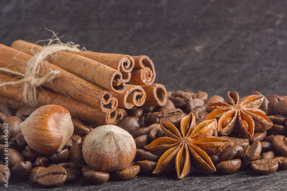 Close-up, roasted coffee seeds, tubberry, cinnamon sticks and chocolate. Close-up, roasted coffee seeds, tubberry, cinnamon sticks and chocolate.
