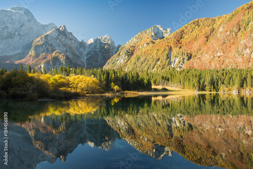 Mountain lake Fusine in autumn with reflection, Lake Fusine, Italy, beautiful water landscape background