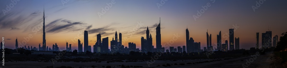 Panorama der Skyline von Dubai mit Silhouette der Wolkenkratzer im Gegenlicht fotografiert Abends bei klarem Himmel im November 2014