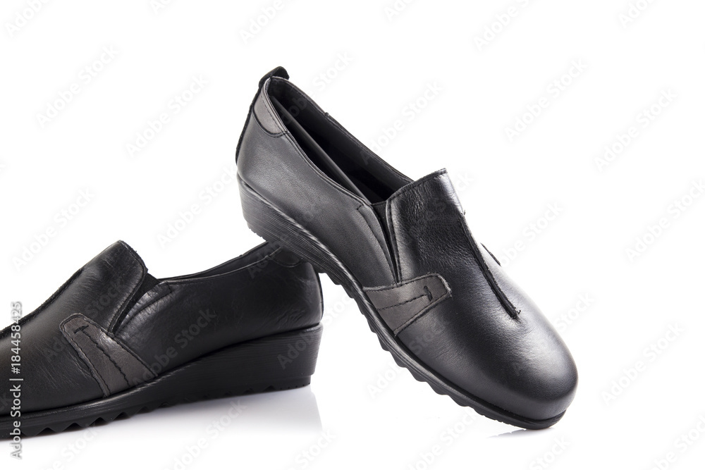 Female black leather shoe on white background, isolated product, comfortable footwear. Female black leather shoe on white background, isolated product, comfortable footwear.