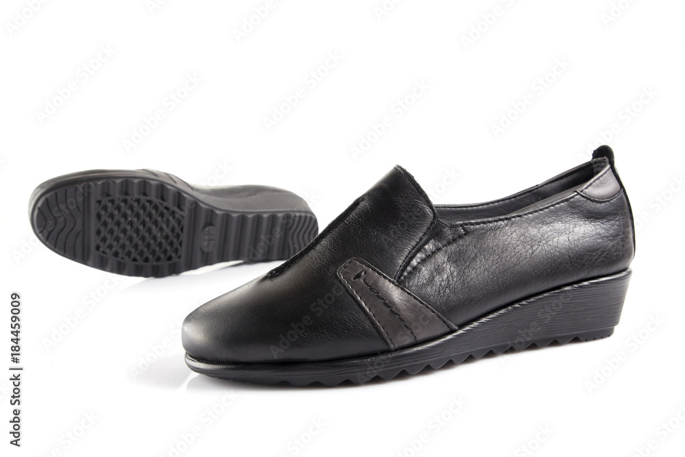 Female black leather shoe on white background, isolated product, comfortable footwear. Female black leather shoe on white background, isolated product, comfortable footwear.