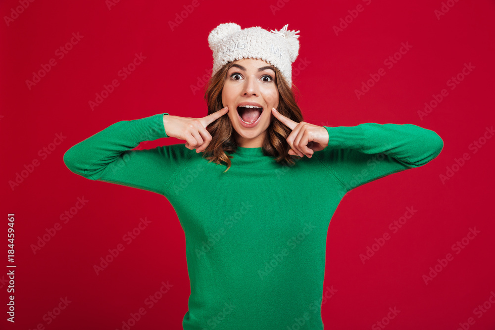 Cheerful brunette woman in sweater and funny hat Cheerful brunette woman in sweater and funny hat