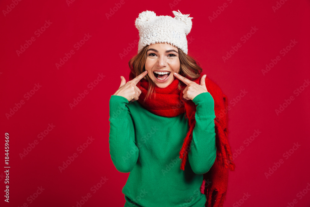 Smiling brunette woman in sweater, funny hat and scarf Smiling brunette woman in sweater, funny hat and scarf