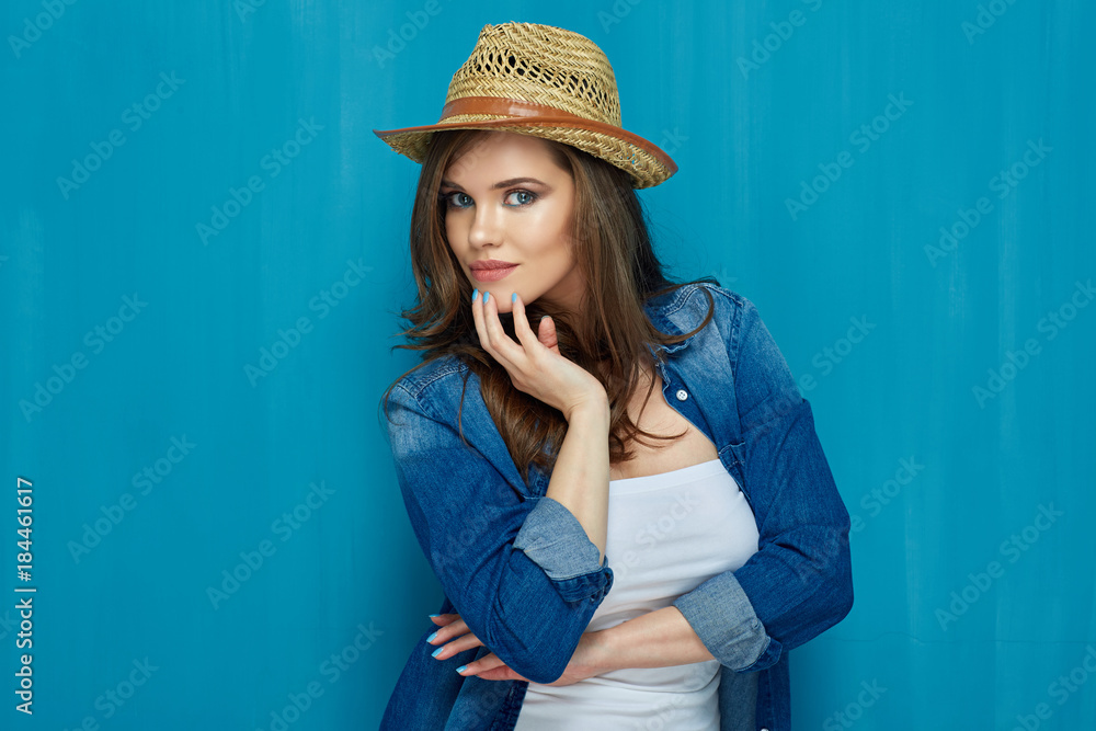 Beautiful girl posing in fashion style against blue wall backgro Beautiful girl posing in fashion style against blue wall backgro