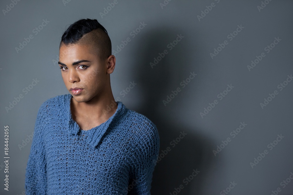 Fototapeta premium Portrait of confident transgender against gray background