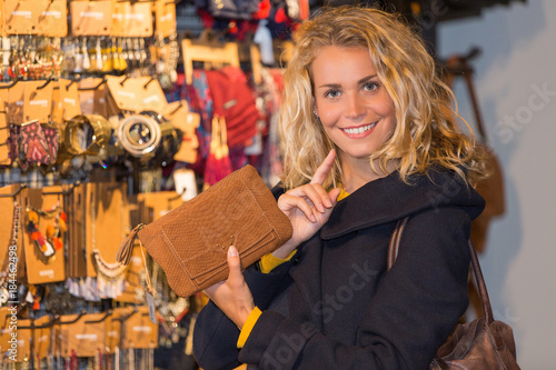 happy woman enjoys in clothing shop