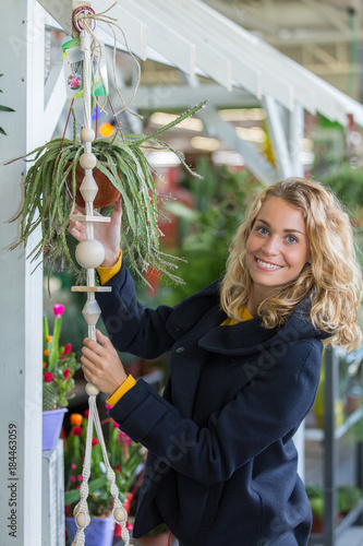 young woman buying grasy plants photo