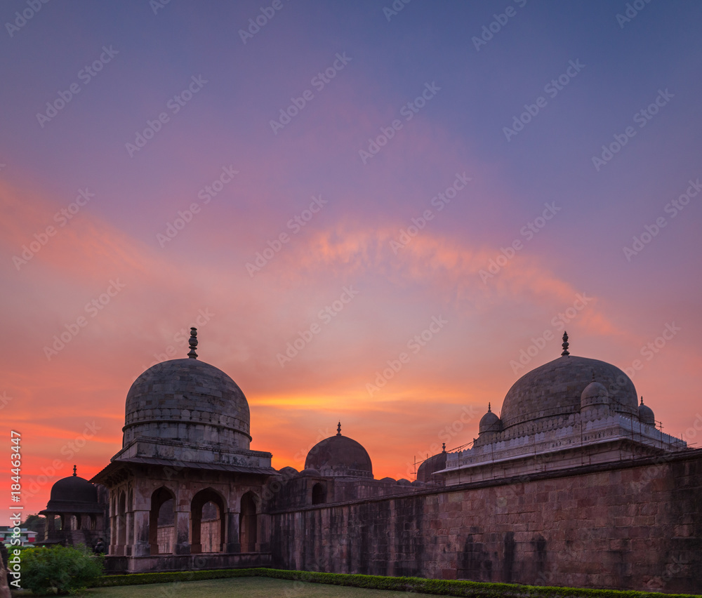 Mandu India, afghan ruins of islam kingdom, mosque monument and muslim tomb. Colorful sky at sunrise, Ashrafi Mahal.
