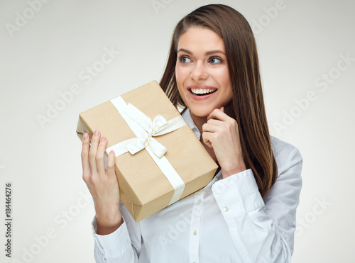 Business woman holding big gift box looking at side.