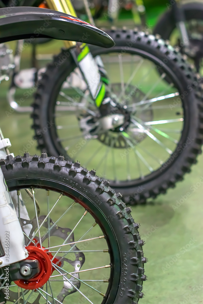 sports racing motorcycles lined up front wheel with shiny spokes sports racing motorcycles lined up front wheel with shiny spokes