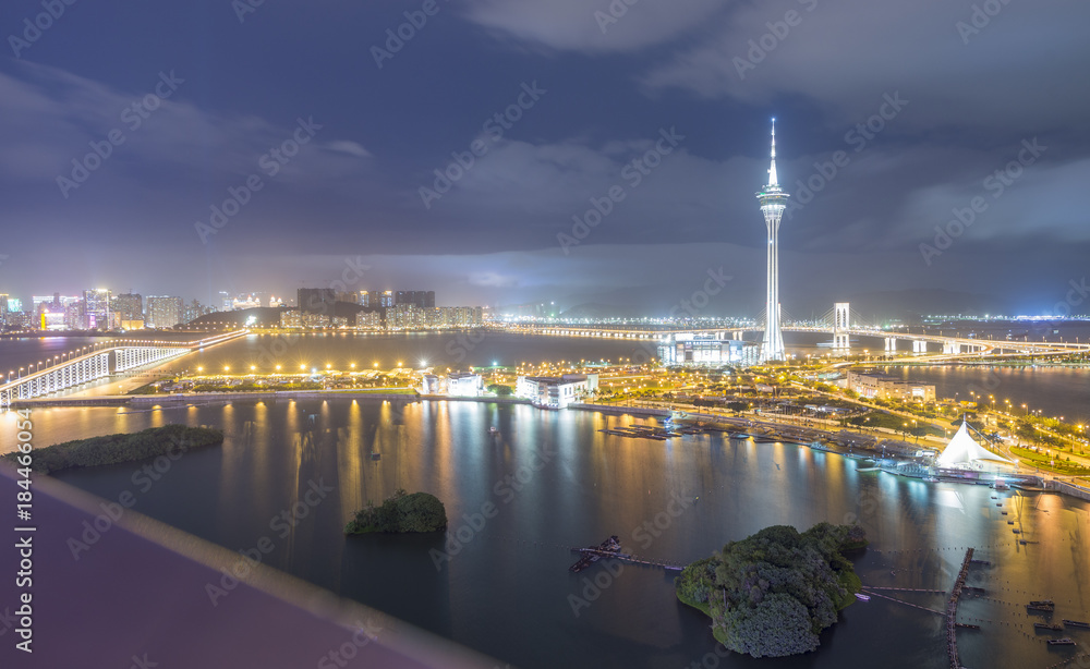 MACAU, CHINA - APRIL 2014: City skyscrapers at night. Macau attracts 20 million people annually