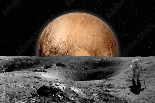 Fototapeta Naklejka Na Ścianę i Meble -  Astronaut on moon surface. Mars in background. Elements of this image furnished by NASA