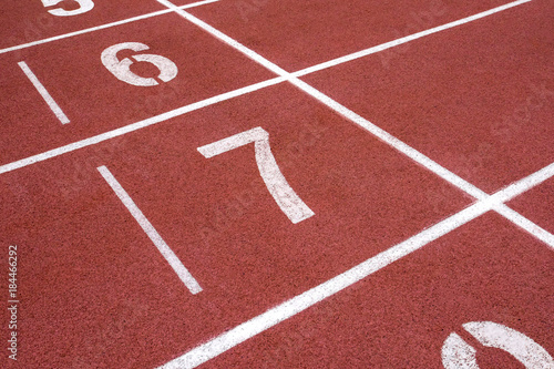 red running track on athletic stadium background texture