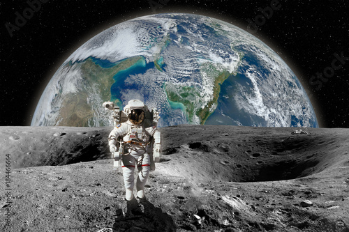 Fototapeta Naklejka Na Ścianę i Meble -  Astronaut on the Moon. Planet earth in background. Elements of this image furnished by NASA