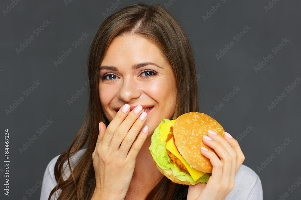 Close up portrait of woman eating burger