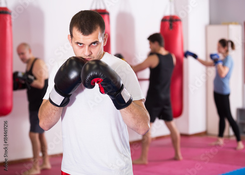 calm sportsman in the boxing hall practicing boxing punches