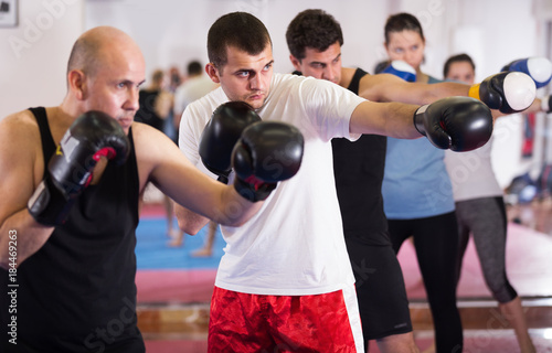 Portrait of men training at sparring together © JackF