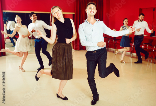 Positive people dancing twist in pairs
