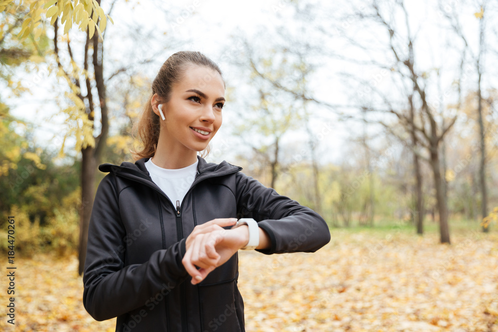 Portrait of a smiling sportswoman in earphones Portrait of a smiling sportswoman in earphones