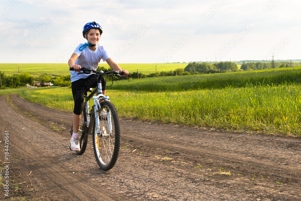 girl on a bicycle in rural landscape girl on a bicycle in rural landscape