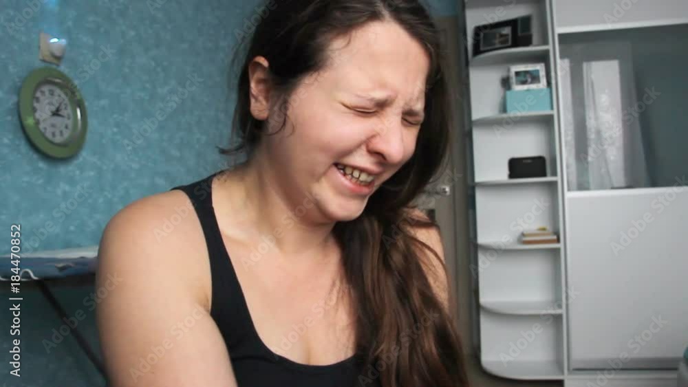 Woman desperate at home. Victim of Abuse Violence. Caucasian girl with long brown hair crying in her room with blue and white. Fat body with overweight. Postpartum Depression Woman desperate at home. Victim of Abuse Violence. Caucasian girl with long brown hair crying in her room with blue and white. Fat body with overweight. Postpartum Depression