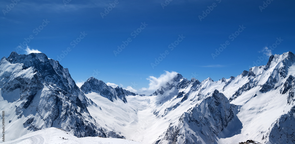 Panoramic view of snow covered mountain peaks