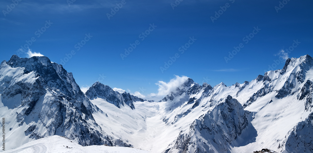 Panoramic view of snow covered mountain peaks Panoramic view of snow covered mountain peaks