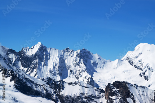 Winter snowy mountains and beautiful blue sky in cold sun day © BSANI