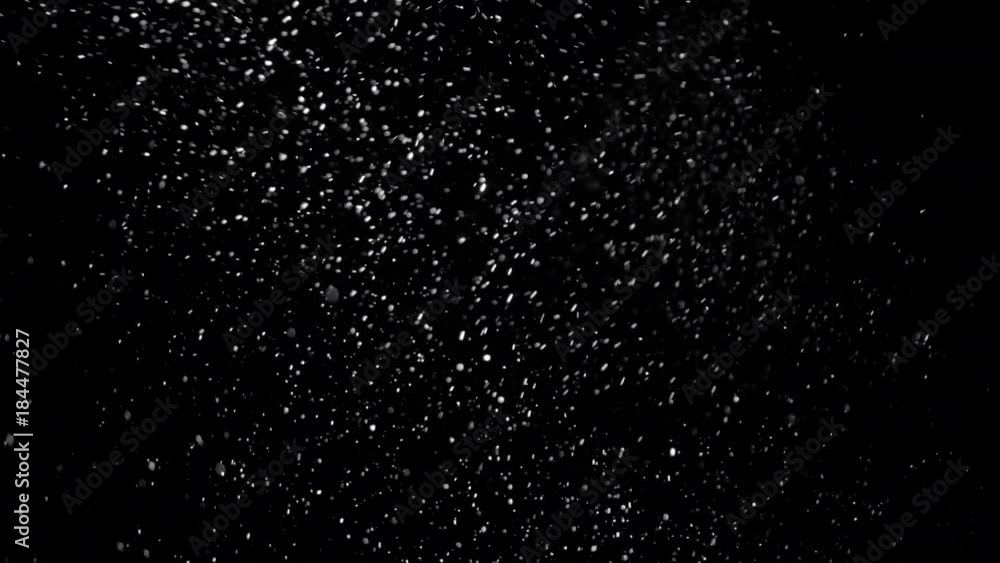 Stockvideo Several snow particles falling down over a black background ...