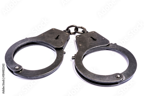 black metal handcuffs with small scratches on white background