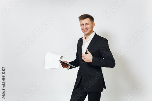 Young successful handsome rich business man in black suit working with documents tablet isolated on white background for advertising. Concept of money, achievement, career and wealth in 25-30 years.