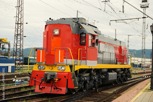 red locomotive in a railway station..