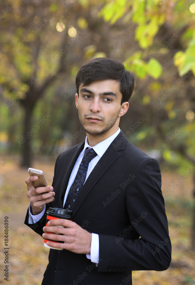 Young handsome man standing on nature at hand telephone thoughtful Young handsome man standing on nature at hand telephone thoughtful