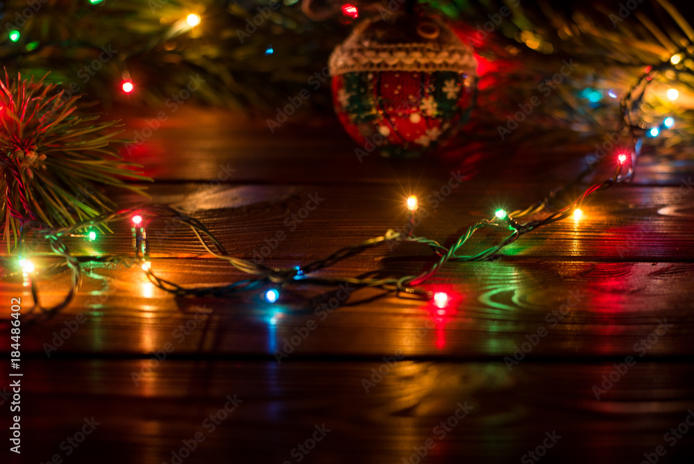 Wreath and garlands of colored light bulbs.Christmas background with lights  and free text space. Christmas lights border. Glowing colorful Christmas  lights on wooden background. New Year. Stock-bilde | Adobe Stock