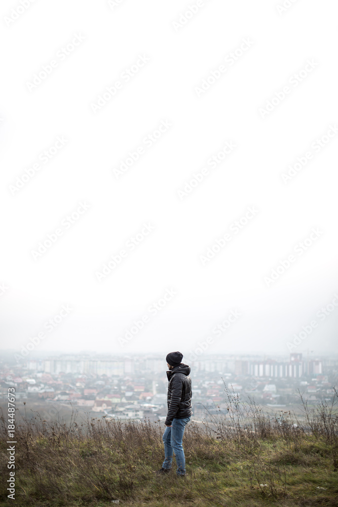 Man looking on the city from the mounten Man looking on the city from the mounten
