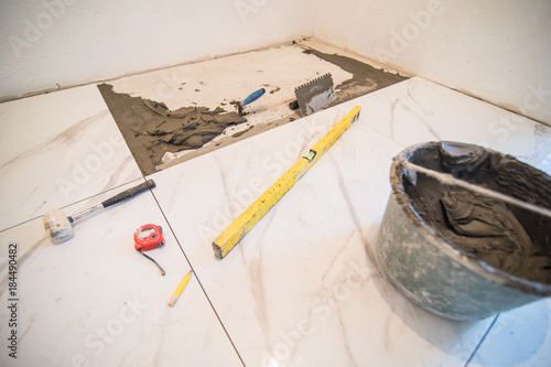 Installation of floor tiles. Ceramic tiles and different tools home